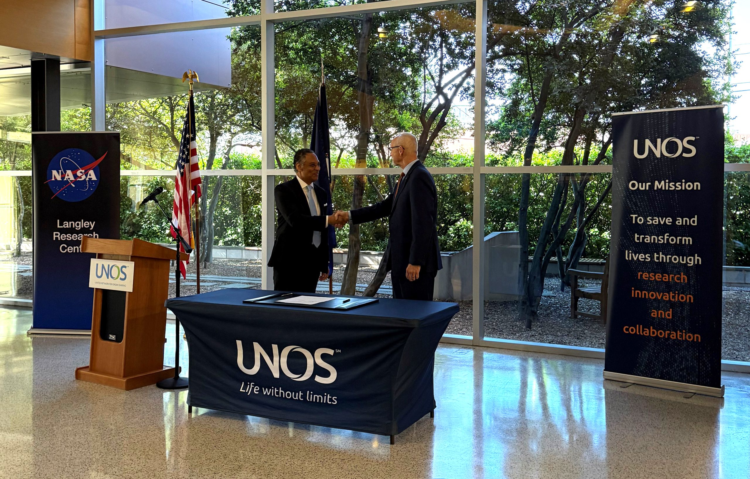 Mark Johnson, interim CEO of UNOS, and John Koelling, director of aeronautics research at NASA Langley Research Center, sign a partnership agreement to study drone transport for organs.