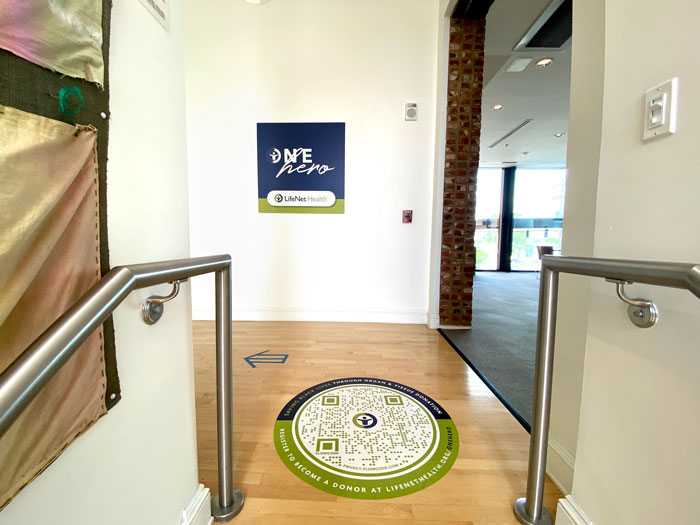 Inside Richmond's Black History Museum & Cultural Center of Virginia. Circular code on floor and signage on wall pointing to exhibit space