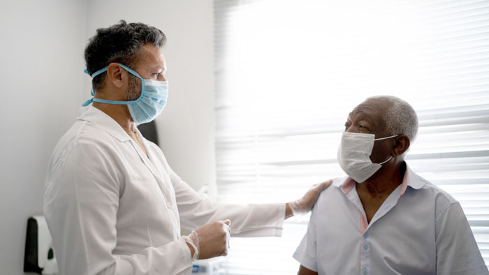 Doctor with hand on patient's shoulder