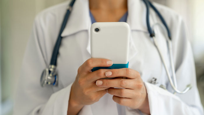 Healthcare provider holding a smart phone