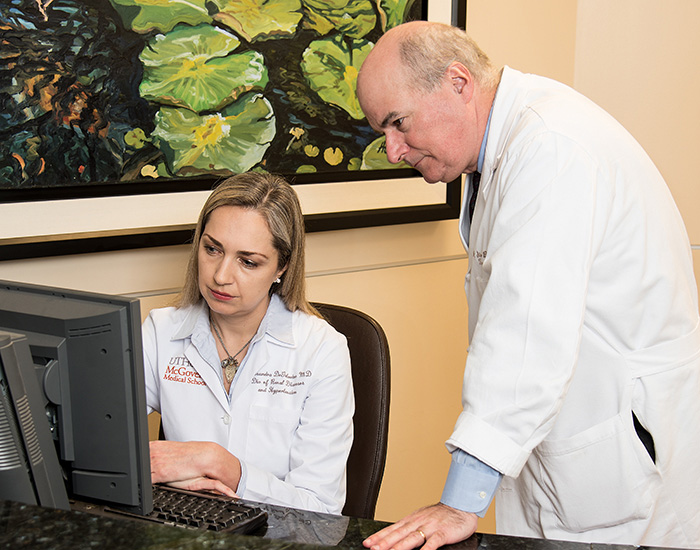 Dr. De Golovine and Dr. Bynon reviewing a kidney offer