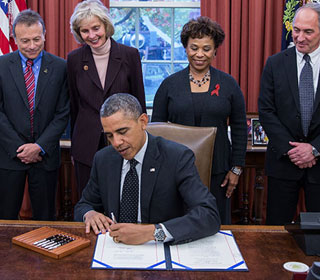 President Barack Obama signs S. 330: HIV Organ Policy Equity Act during a signing ceremony in the Oval Office, Nov. 21, 2013. (Official White House Photo by Lawrence Jackson)