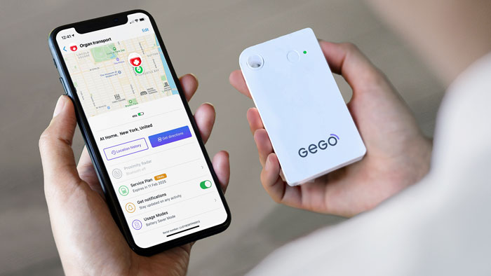 Hands holding an iphone with screen displaying map with location indicator, next to a white GEGO tracking device