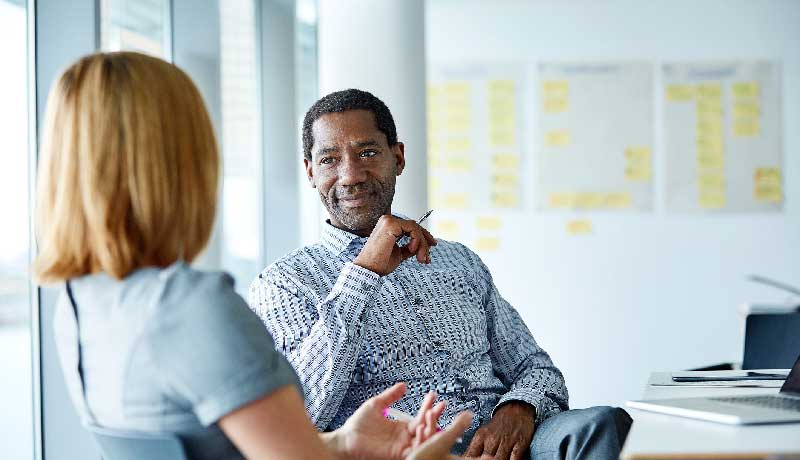 two people talking in office