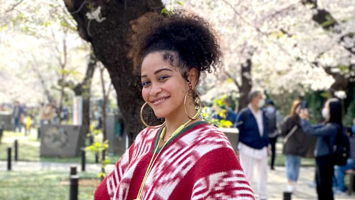 Shawna Robinson smiling with tree in bloom in the background