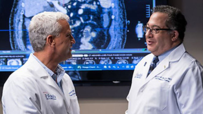700x394-Andreoni-and-Johnson Mark Johnson, M.D. and Kenneth Andreoni, M.D. talking